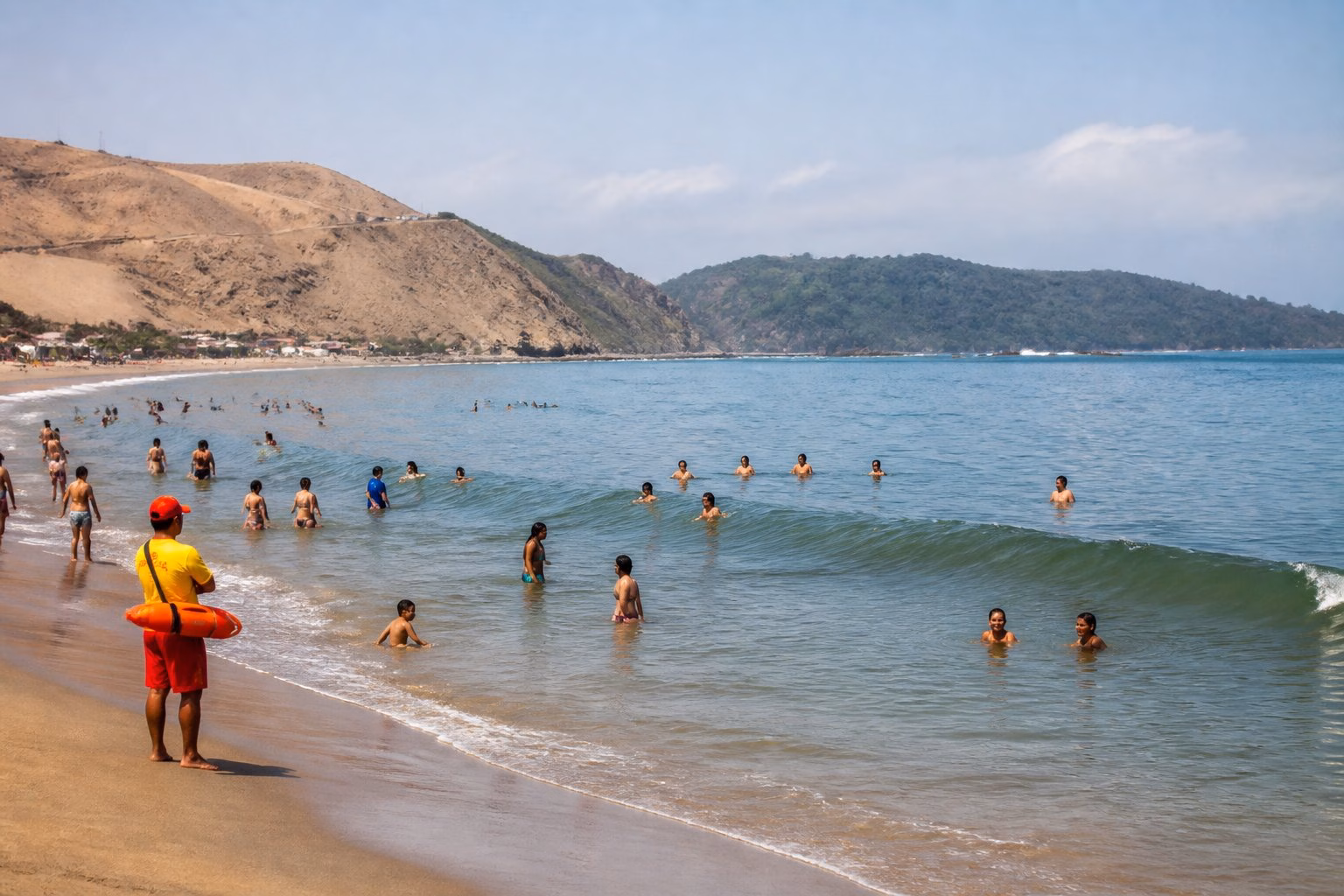Swimmers enjoy unusually warm sea water along a South American coast, with a dry shoreline contrasting with greener distant land.