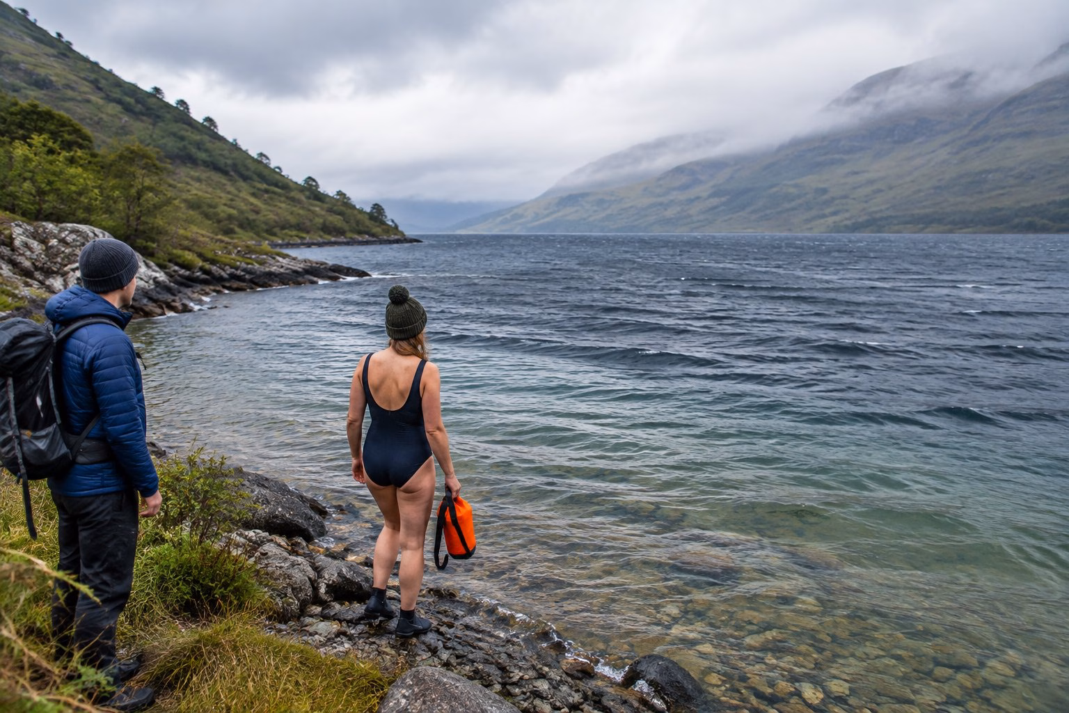 A swimmer checks the conditions beside a sheltered Highland loch.